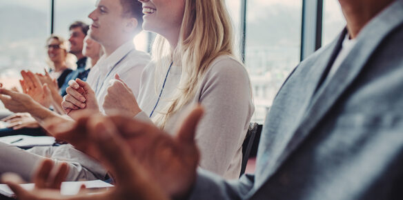Businesspeople clapping hands after successful conference