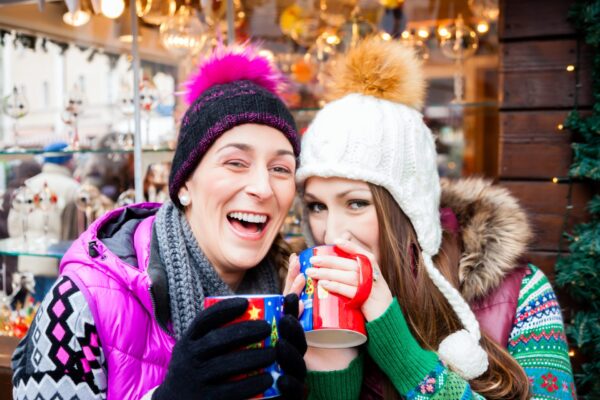 Friends drinking eggnog on Christmas Market