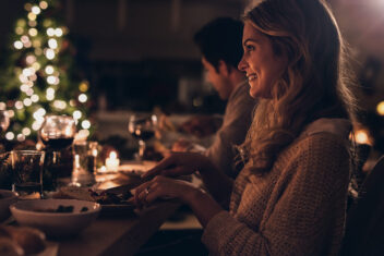 Beautiful woman having christmas dinner with family